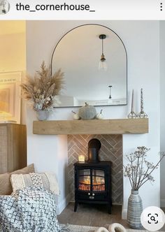 a living room filled with furniture and a fire place next to a mirror on the wall