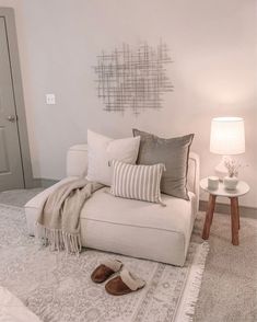 a living room filled with furniture and pillows on top of a white carpeted floor