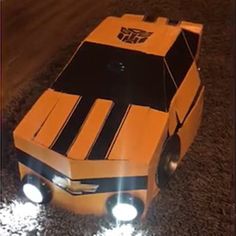 an orange and black car with lights on it