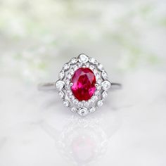 Beautiful Vintage Inspired Ruby Ring Made of Solid Sterling Silver, Rhodium Plated (925) Can be paired with one or two half-eternity Milgrain bands of your choice Accented with Simulated Diamonds (CZ) Center Stone: Ruby Grade: AAA Stone Cut: Oval Gem size: 7.0 x 5.0 mm Carat Weight: 0.76 (approx.) Gemstone creation: 100% Genuine Lab-Grown Ruby Stone Origin: Russia Handling time: 1-2 business days Free domestic shipping. Usually takes 2-5 business days. Wrapped & ready to give in a beautiful Classic Promise Ring With Lab-created Ruby, Classic Lab-created Ruby Rings For Promise, Classic Ruby Ring With Halo Design, Classic Rings With Lab-created Ruby For Gift, Classic Oval Lab-created Ruby Ring, Classic Round Ruby Ring With Halo Design, Classic Ring With Prong-set Lab-created Ruby, Classic Promise Jewelry With Lab-created Ruby, Classic Lab-created Ruby Jewelry For Promise