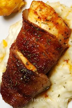 some meat and mashed potatoes on a white plate