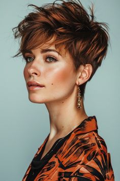 Woman with a modern short hairstyle and subtle makeup posing in a tiger print outfit against a light blue background. Growing Out Pixie Cut, Grown Out Pixie, Shaggy Short Hair