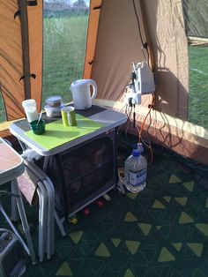 the inside of a tent with tables and chairs