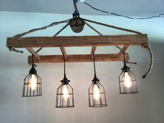 four light fixtures hanging from a wooden beam