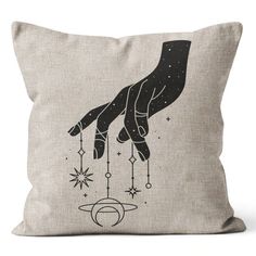 a pillow that has a hand reaching for the stars on it, with an image of a