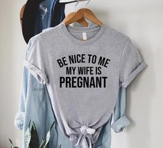 "Funny New Dad Shirt,Dad Announcement,New Dad Gift,Dad To Be T-Shirt, Be Nice To Me My Wife Is Pregnant T-Shirt,Expecting Dad ----- How To Order ----- 1-) Please, check and review all the photos. 2-) Choose your t-shirt size and color. *Different styles of shirts may have different shades of same color choice due to different manufacturer brands. *For this reason, we recommend you to match shirts from the same styles if you want precisely matching colors (ex. Unisex, V-necks, Toddler, etc.). 3-) Beach Pregnancy Announcement, Pregnant Mom Gifts, Pregnant Shirt, Be Nice To Me, Husband Funny, Funny Pregnancy Announcement, Dad To Be, Pregnancy Announcement Gifts, Pregnancy Announcement Shirt