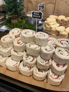 a table topped with lots of sandwiches and cookies