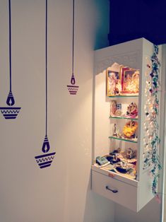 an open refrigerator with hanging decorations on the wall