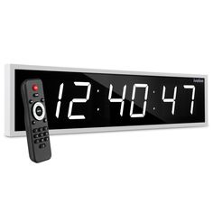 an alarm clock with remote control on white background