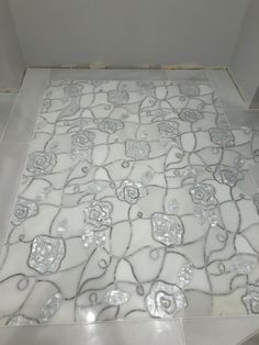 a white toilet sitting in a bathroom next to a tiled floor