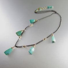 "This necklace is made from Arizona turquoise that is a green/blue color and has natural matrix inclusions. The stones measure 15x8mm. I have used gold filled wire to wrap the trillion cut stones and attached them to oxidized sterling silver chain. I like the rustic nature of oxidized silver, plus it has another benefit of never needing to be polished. The necklace measures 20\" in length. At the end are 4 links to close the necklace. A lobster claw clasp makes it a bit easier to attach. I can a Turquoise Necklace For Jewelry Making With Chrysocolla, Chrysocolla Turquoise Necklace For Jewelry Making, Turquoise Chrysoprase Gemstone Necklace, Turquoise Chrysoprase Necklace, Trendy Silver Jewelry, Watermelon Tourmaline Necklace, Jewelry 2023, Arizona Turquoise, Tourmaline Necklace