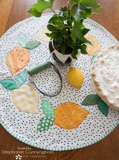 a potted plant sitting on top of a table next to a cake and scissors