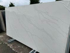 a large white marble slab sitting on the ground