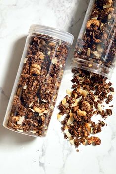 two cups filled with granola sitting on top of a counter