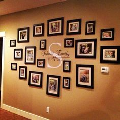 a wall with many pictures on it and the words family is displayed in black frames