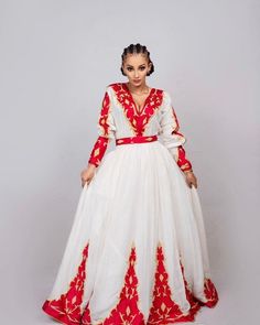 This Habesha dress is a true work of art, made of soft and luxurious Menen fabric in a regal red color. The dress features a stunning Tilf embroidery design, covering the entire dress with intricate patterns and designs that are unique to Ethiopian traditional clothing. The Tilf embroidery adds a touch of elegance and sophistication to the dress, featuring delicate patterns and designs that are sure to turn heads. The dress is designed with a fitted bodice that accentuates the waistline and flar Red Kaftan For Eid Traditional Ceremonies, Red Ceremonial Kaftan For Eid, Traditional Red Embroidered Maxi Dress, Traditional Embroidered Red Maxi Dress, Traditional Red Maxi Dress For Eid, Traditional Red Embroidered Thobe, Ceremonial Red Dress With Traditional Patterns, Red Dress With Intricate Embroidery For Traditional Ceremonies, Red Embroidered Thobe For Eid