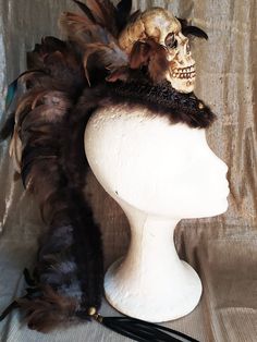 Awesome mohawk headpiece with a big skull as a center piece. The perfect mohawk to make your festival outfit complete. Brown and grey feathers around the skull and all covered with a braided brown trim and fur on the sides for an ultimate steampunk look. Light and easy to attach to the hair, this headpiece stays in place all day and night long, super confortable and party proof! Long feathers on the back side with a faux leather fringe for a more extravagant look. - - - - - - - - - - - - - - We Steampunk Halloween Festival Headpiece, Gothic Headpieces For Carnival Festival, Fantasy Costume Hat With High Crown For Festivals, Gothic Festival Costume Hat With Tall Crown, Fantasy Costume Hat With Tall Crown For Festivals, Fantasy Tall Crown Costume Hat For Festival, Fantasy Festival Headpiece With High Crown, Punk Costume Accessories For Carnival Festival, Punk High Crown Costume Hat For Festivals