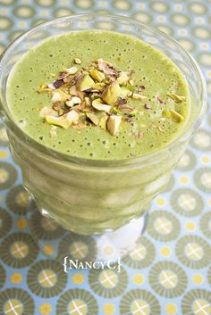 a green smoothie with nuts on top