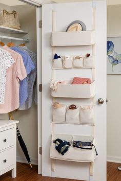 a white closet door with hanging baskets and clothes on the shelves, next to a pair of shoes