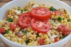 a white bowl filled with rice and tomatoes