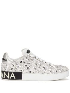 Silver-tone leather Portofino crystal-embellished sneakers from DOLCE & GABBANA featuring logo patch at the tongue, crystal embellishment, round toe, front lace-up fastening, contrasting heel counter and flat rubber sole. | Dolce & Gabbana Portofino crystal-embellished sneakers Leather Low-top Sneakers With Rhinestones, Luxury Leather Sneakers With Rhinestones, Luxury Embellished Leather Sneakers, Embellished Leather Lace-up Sneakers, Luxury White Sneakers With Rhinestones, Luxury White Custom Sneakers With Rhinestones, Luxury Embellished Lace-up Sneakers, Luxury Embellished White Sneakers, Luxury Silver Custom Sneakers