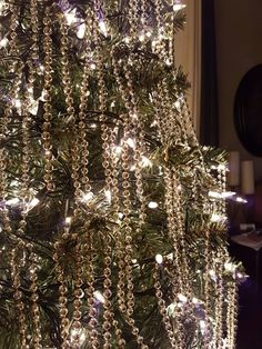 a christmas tree is decorated with lights and beads