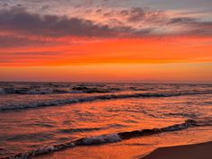 an orange and pink sunset over the ocean