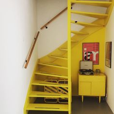 the stairs are painted bright yellow in this room