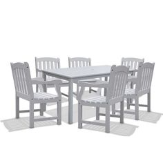 a white table and four chairs on a white background with no one around it,