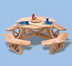 a wooden table with four benches and two cups on it, set against a blue background