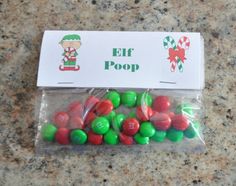 a bag filled with green and red candies next to a sign that says elf poop