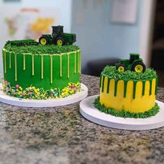 two cakes decorated with green icing and yellow frosting on top of a counter