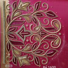 an intricately designed card with gold threadwork and beads on it's side