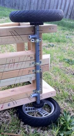 a scooter made out of wooden pallets with wheels attached to the back