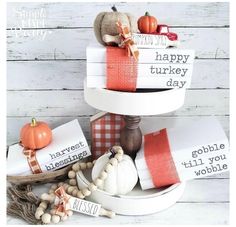 three tiered trays with thanksgiving decorations and tags on them, sitting next to each other