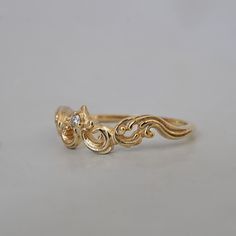 a close up of a gold ring on a white surface