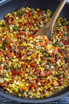 a skillet filled with corn and vegetables