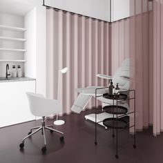 a white chair sitting next to a table on top of a hard wood floor in front of a pink striped wall