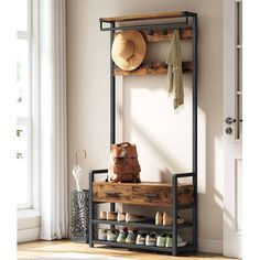 an entryway with shoes and hats on the shelf, next to a bench in front of a window