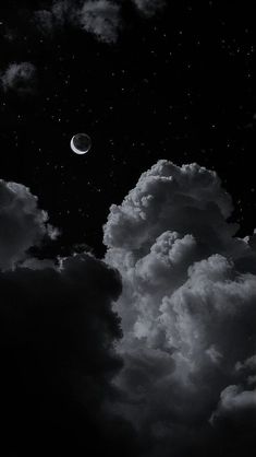 black and white photograph of the moon in the sky with clouds around it at night