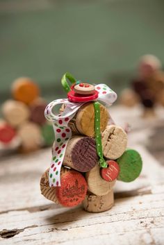 a close up of a small tree made out of wine corks with a ribbon