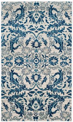 a blue and white rug with an ornate design