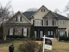 a house with a for sale sign in front of it and a mailbox on the lawn