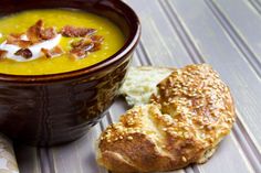 a bowl of soup with bread on the side