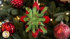 a christmas ornament hanging from the side of a tree with ornaments around it