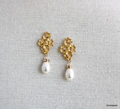 These elegant pearl earrings have small flower pendants in gold plated finish and Austrian teardrop pearls.   Pearls measure 11 x 8 mm. Earrings are approximately 1 1/2" long from top to bottom by 1/2" wide.   Each flower has a tiny clear cubic zirconia in the center.  Post is .925 sterling silver over brass.   Please choose desired pearl color and finish at checkout.  Perfect for any nature inspired bride! Matching necklace, https://www.etsy.com/listing/274801382/backdrop-pearl-necklacecrystal? Gold Pearl Flower Earrings For Wedding, Elegant Gold Pear-shaped Bridal Earrings, Delicate Gold Pearl Chandelier Earrings, Gold Pearl Chandelier Earrings Delicate Style, Gold Pearl Chandelier Earrings In Delicate Style, Gold Teardrop Pearl Earrings With Pearl Charm, Gold Teardrop Earrings With Pearl Charm, Gold Pearl Teardrop Dangle Earrings, Gold Pearl Teardrop Earrings With Pearl Drop