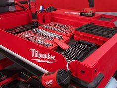 a red tool box filled with tools and wrenches