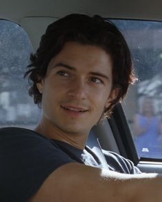 a man sitting in the passenger seat of a car