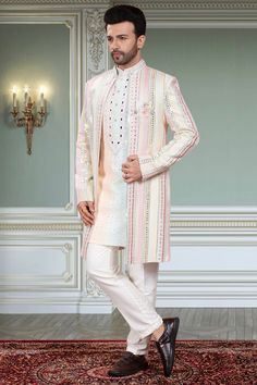 This Mens Sherwani is a stunning addition to any wardrobe. The mirror embroidery open jacket sherwani creates a unique and fashionable look, perfect for special occasions. Made with high-quality materials, this sherwani exudes both style and comfort. Transform your outfit and make a statement with this S2-S376 Sherwani. Designer Nehru Jacket With Mirror Work For Weddings, Designer Long Sleeve Sherwani With Mirror Work, Long Nehru Jacket With Naqshi For Festive Occasions, Designer Long Sleeve Nehru Jacket With Mirror Work, Bollywood Style Long Sleeve Sherwani With Mirror Work, Traditional Festive Long Coat Bandhgala, Designer Bandhgala With Mirror Work And Long Sleeves, Designer Long Sleeve Bandhgala With Mirror Work, Designer Long Bandhgala With Zari Work