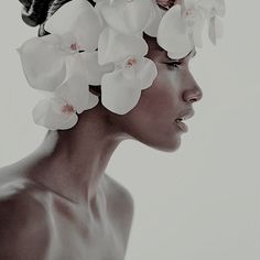 a woman with white flowers in her hair